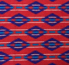 a red and blue rug with an interesting design