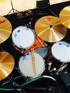 several drums and sticks are sitting on a table