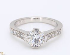 a diamond engagement ring with three stones on the band and side stones around the band