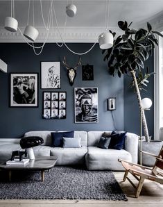 a living room filled with furniture and pictures on the wall