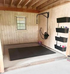 the inside of a shed with wood paneling and shelving