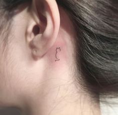 a small cat tattoo on the left ear