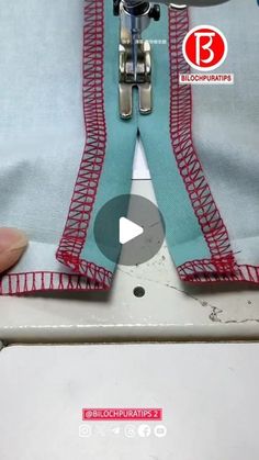 someone is using a sewing machine to sew on the side of a piece of fabric