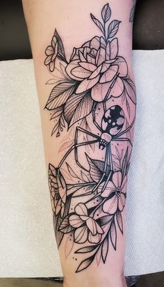 a black and white flower tattoo on the leg