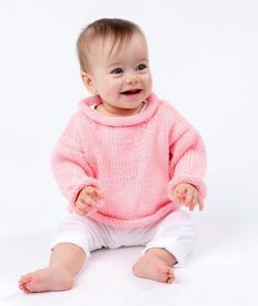 a baby wearing a pink sweater and white pants with the words pretty - n - pink baby pullover