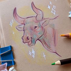 a drawing of a bull's head with stars on it and colored pencils next to it