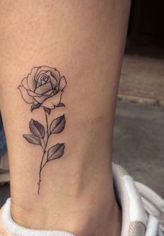 a small rose tattoo on the ankle