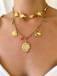 Experience the perfect combination of beachy charm and Greek craftsmanship with our Gold Summer Shell Necklace. Made with vibrant enamel stones and durable stainless steel chains, these handmade necklaces embody the essence of summer. The shorter one is designed as a choker, while the longer one features a stunning gold shell charm at the center. Whether worn together or separately, these necklaces are a must-have for any summer lover. Only available at Christina Christi Store. MATERIALS - Metal Rebecca Black, Beach Necklace, Beach Necklaces, Shell Necklace, Shell Pendant, Shell Necklaces, Girls Jewelry, Kids Jewelry, Girls Bags