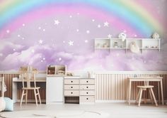 a child's room with a rainbow painted on the wall and stars in the sky