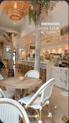 the inside of a restaurant with tables, chairs and chandeliers hanging from the ceiling