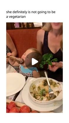 a woman holding a baby in her lap and eating broccoli with a spoon