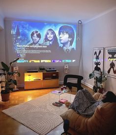 a living room filled with furniture and a flat screen tv mounted to the side of a wall