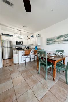 a kitchen and dining room with tile flooring