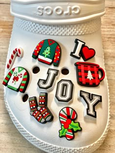 a pair of white shoes with christmas decorations on the soles and i love you buttons