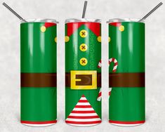 two green christmas soda cans with straws in them