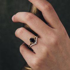 a person's hand with a ring on it