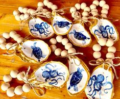 blue and white cookies decorated with sea animals are on a wooden table next to eggs