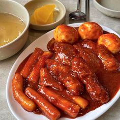 a white plate topped with meat covered in sauce