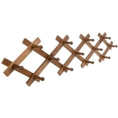 a wooden rack with four pegs attached to it