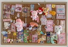 a bulletin board filled with lots of stuffed animals and other stuff on top of it