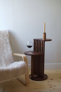 a chair and table with a wine glass on it