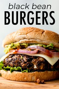 a close up of a burger on a wooden table with the words black bean burgers