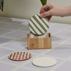 Bring trendy color & playful patterns to a coffee table or dining surfaces with the stoneware clay Havana Coaster Set. This set of 4 unique, hand painted coasters comes in a bamboo box & features burnt orange polka dots, white checkerboard on natural bisque, green & white stripes, & purple waves. Perfect for merchandising in plant shop or home & gift stores, this set offers a handmade look & organic design to interiors. 4in W x 1.5in D x 4in H Finish: Multi Material: Ceramic Includes 2 Sets of 4 Handmade Clay Coasters, Ceramic Coaster Painting Ideas, Coaster Ideas Painted, Ceramic Coaster Ideas, Clay Coaster, Hype Decor, Clay Coasters, Hand Painted Coasters, Purple Waves