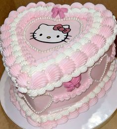 a hello kitty heart shaped cake on a plate