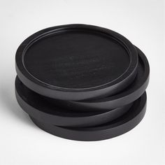 three black plates stacked on top of each other