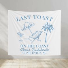 a white wall hanging on the side of a wooden floor with a blue and white sign that says last toast on the coast