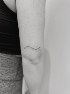 a woman with a small tattoo on her arm