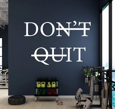 a gym with the words don't quit written on the wall next to it