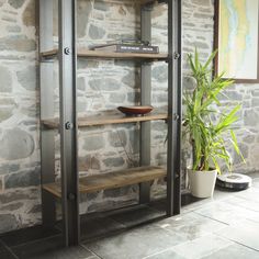 a room with stone walls and shelves on the wall is filled with books, plants, and other decorative items