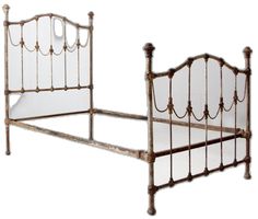 an old iron bed frame with white sheets