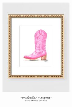 a pink cowboy boot is framed in a gold frame