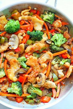 chicken stir fry with broccoli, carrots and mushrooms in a skillet