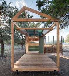 a small wooden structure sitting in the middle of a forest