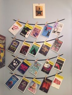 a bulletin board with several books on it and clothes pins attached to the magnets