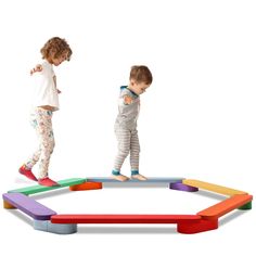 two children are playing on an inflatable play structure with colored blocks and sticks