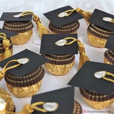 graduation cupcakes in gold foil wrapped in black paper and decorated with golden tassels