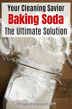 a jar filled with baking soda sitting on top of a wooden table next to a spoon