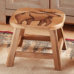 a wooden stool with an image of a moose on it