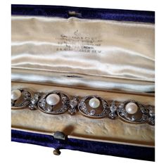 Exquisite Collector Edwardian/Belle Epoque Natural Pearl and Diamond Bracelet, fitted in its original case by Garrard & Co, circa 1900. The first official Crown Jeweler for the British royal family, Garrard & Co. Limited has crafted iconic and historically celebrated rings, watches, necklaces and other jewelry for centuries. An Edwardian pearl and diamond bracelet, consisting of eight oval-shaped diamond-set openwork links, each to the centre with a round natural pearl set between two old-cut di Antique Formal Bracelets With Box Clasp, Victorian Bracelets With 17 Jewels For Evening, Vintage Formal Bracelet With Box Clasp, Victorian White Gold Bracelets For Formal Occasions, Victorian Style White Gold Bracelets For Formal Occasions, Victorian Bracelets For Anniversary, Antique Evening Bracelets, Victorian Bracelets With Intricate Design For Formal Occasions, Victorian White Gold Bracelets Gift