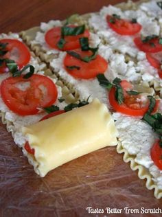 some ravioli with tomatoes and cheese on a wooden table