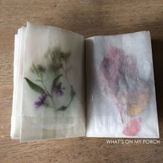 two napkins with flowers on them sitting next to each other