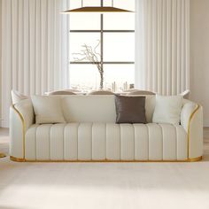 a white couch sitting in front of a window