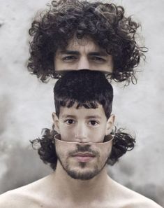 two men with curly hair and glasses on their faces