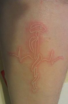 a person with a tattoo on their arm has a stethoscope in the shape of a medical symbol