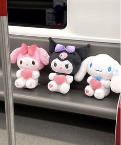 three stuffed animals are sitting on a shelf