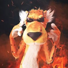 a stuffed animal that is standing in the fire